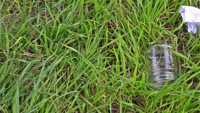 Pollution.Garbage abandoned in a meadow of grass