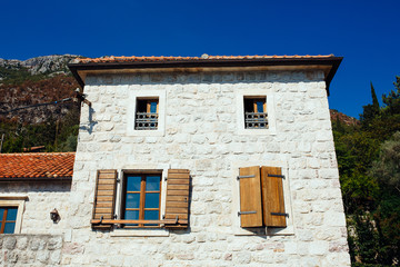 House with wooden shutters and door. Montenegro