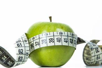 Green apple and measuring tape
