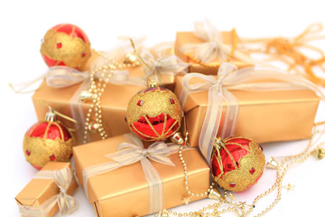 Fototapeta na wymiar Golden gift boxes with golden ribbon and chrismas balls on white