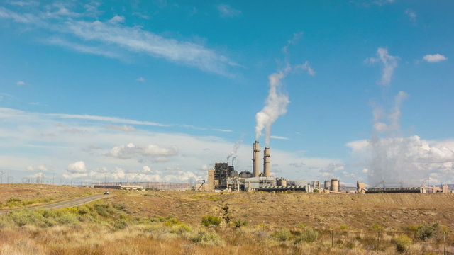 Wide panorama vista shot of electricity power plant generating station with smoke from chimneys stacks