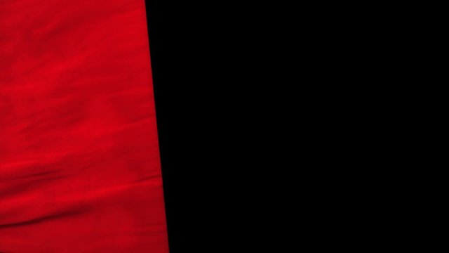 Waving red cloth on black background shooting with high speed camera, phantom flex