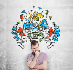 A handsome young man in casual clothes is forecasting a building of a business plan for business...