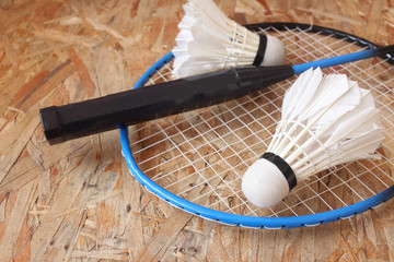 Shuttlecocks with badminton racket.