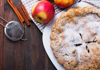 Home made apple pie on the wooden background