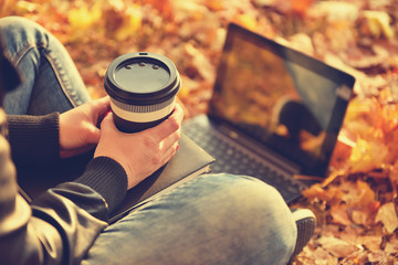 hipster girl in park with laptop