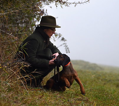 woman hunter with puppy