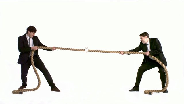 Young business men playing tug-of-war shooting with high speed camera, phantom flex.