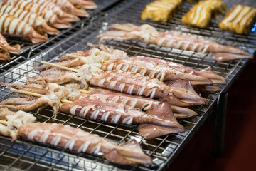 Fried calamari bbq on stick is sold at the Asian street  market