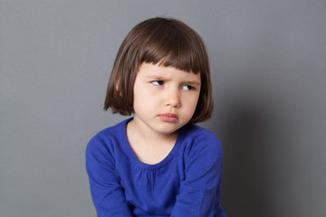 kid attitude concept - grumpy 4-year old child with bob cut sulking with dirty look for complain or disagreement,studio shot