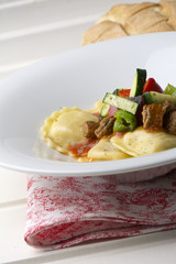 fresh meat tortellini with tomato and sauteed vegetables