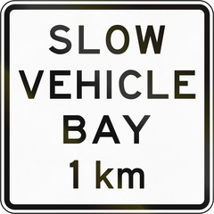 New Zealand road sign - Slow vehicle bay ahead in 1 kilometre