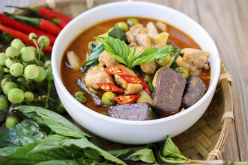 Thai chicken green curry with old wooden background