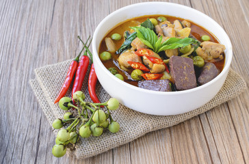 Thai chicken green curry with old wooden background