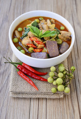 Thai chicken green curry with old wooden background