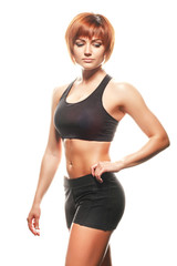 Fototapeta premium Portrait of redhead woman in sportswear. Studio shot