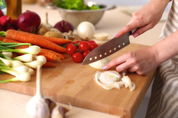 Young Woman Cooking in the kitchen. Healthy Food