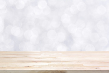 Wood table top on shiny white bokeh abstract background