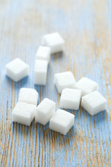white sugar cubes on wooden surface