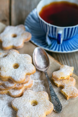 Italian cookies, spoon and a cup of tea.