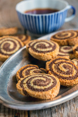 Two-color cookies on a metal tray.
