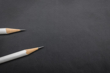two white pencils on black