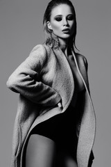 High fashion look.glamor beautiful sexy hot stylish young blond woman model in overcoat in studio