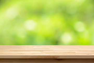 Wood table top on natural green bokeh abstract background