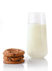 Stack of three homemade chocolate chip cookies and glass of milk, isolated on white background