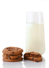 Stack of three homemade chocolate chip cookies, halves of cookies and glass of milk, isolated on white background