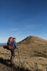 Fototapeta premium Hiker trekking in the mountains. Sport and active life.