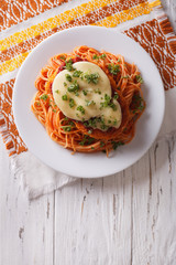Italian chicken Parmigiana and pasta. Vertical top view
