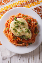 Italian chicken Parmigiana and pasta close up. Vertical top view
