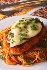 Italian food: Chicken Parmigiana and spaghetti closeup. Vertical
