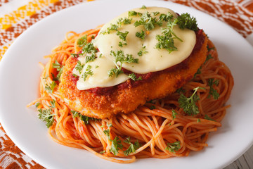 Italian food: Chicken Parmigiana and spaghetti closeup. horizontal
