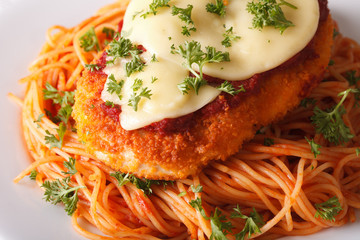 Chicken parmigiana and spaghetti close-up on a plate. horizontal
