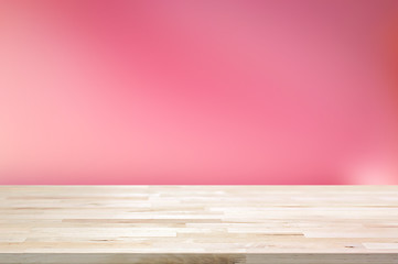 Wood table top on gradient abstract pink background