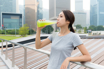 Young Woman drink with vegetable beverage at outdoor