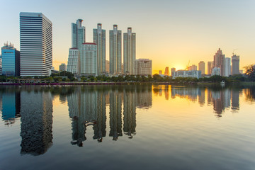 Naklejka na ściany i meble Bangkok city downtown at sunrise with reflection in Bangkok,Thailand