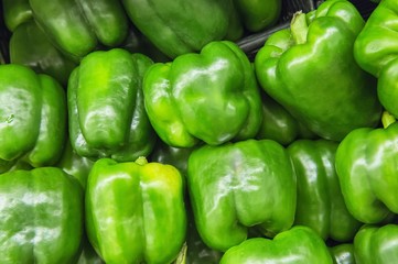 Fototapeta na wymiar fresh green peppers from market shelves real with flaws and brui