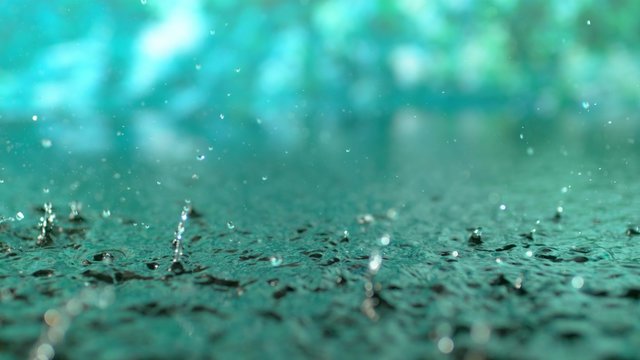 4K 30fps, Heavy rain in puddle with green background shot with high speed camera, phantom flex 4K.