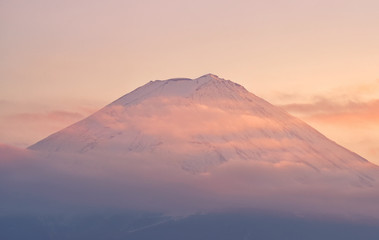 Fototapeta na wymiar Top of Mountain Fuji with clouds in sunset