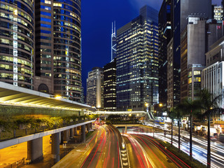 Fototapeta na wymiar the light trails on the modern building background in Hong Kong China