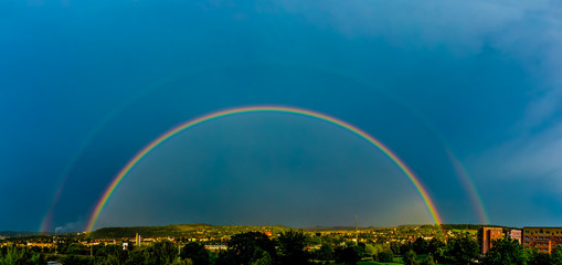Fototapeta na wymiar Panorama of a big summer rainbow