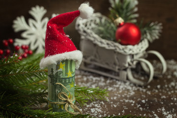 Gift money with red ribbon and Santa cap