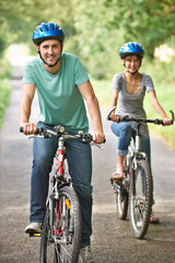 Young Couple Cycling Along Country Road