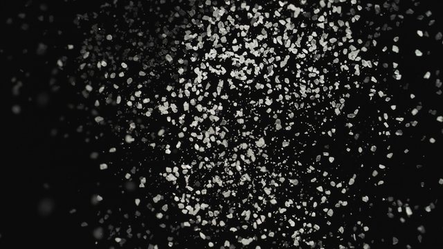 4K 30fps, White particles fly after being exploded against black background shot with high speed camera, phantom flex 4K.