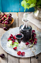 Cherry homemade liquor in a vintage bottle 
