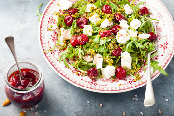 Salad with arugula, cherries and goat cheese.
