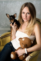 Obraz premium girl with a small dog in the Studio